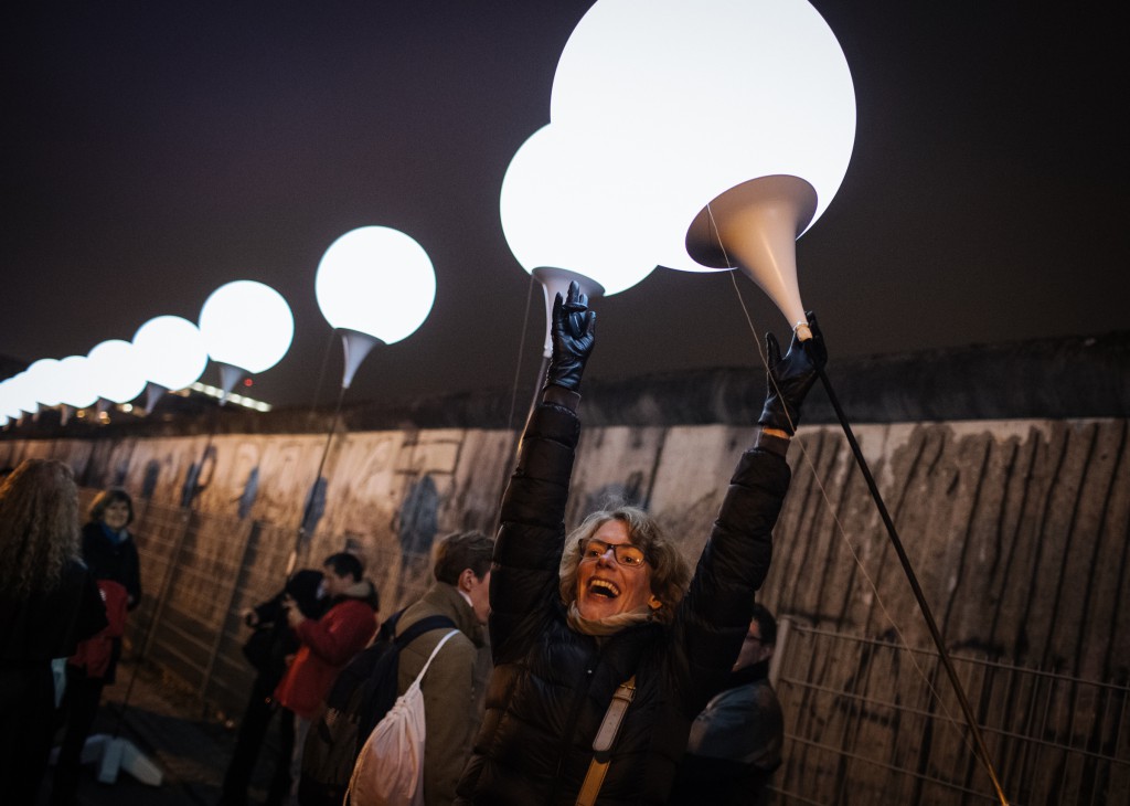 A woman celebrates as she awaits the release of balloons into the sky along the former path of the Berlin Wall in Berlin Nov. 9. Commemorating the 25th anniversary of the fall of the Berlin Wall, Pope Francis said the sudden end to the division of Europe was prepared by the prayers and sacrifice of many people, including St. John Paul II. (CNS photo/Roman Pilipey, EPA) 