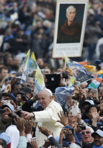 Pope Francis passes a sign showing new saint Ludovico of Casoria as he greets the crowd after celebrating the canonization Mass of six news saints in St. Peter's Square at the Vatican Nov. 24. (CNS photo/Paul Haring) 