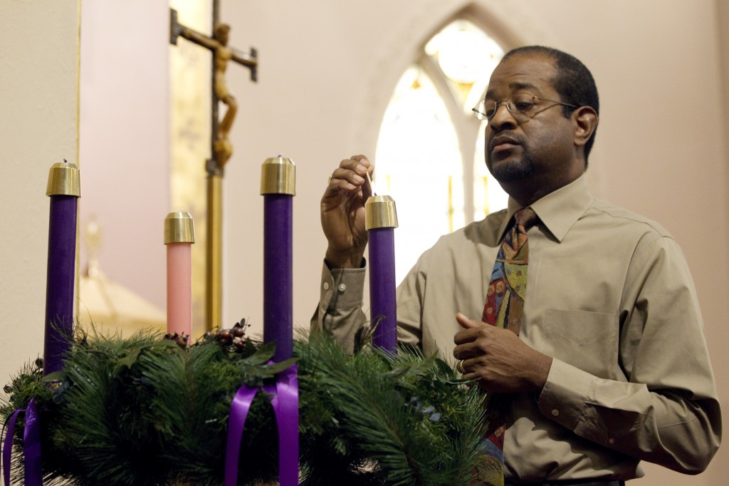 Joe Brooks lights the first candle of the Advent wreath at St. Joseph’s Catholic Church in Alexandria, Va. Nov. 27, 2011. Advent begins this year Nov. 30. Each candle on the wreath marks a Sunday during the period of joyful anticipation that precedes Christmas. (Nancy Phelan Wiechec/CNS)
