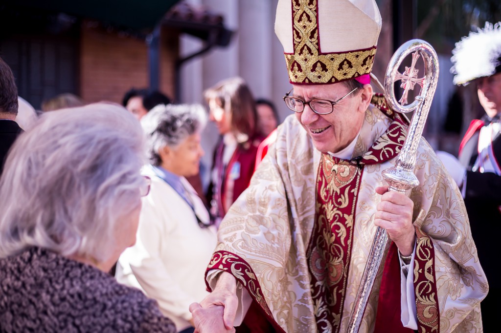 Bishop Thomas J. Olmsted greets churchgoers following a Nov. 23, 2014, Mass to inaugurate the "Year of Consecrated Life" at Ss. Simon and Jude Cathedral.