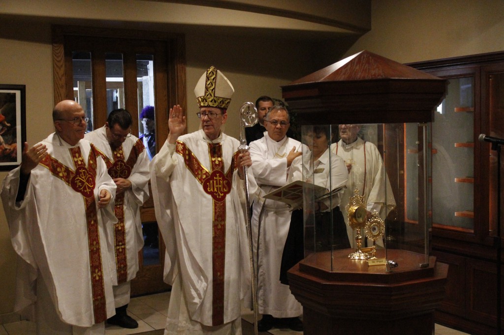 Bishop Thomas J. Olmsted blesses the reliquarium at St. Timothy Parish Nov. 1 as Fr. Charlie Goraieb, pastor, Fr. John Greb, Deacon Gene Messer and Fr. Oliver Mohan look on. The reliquarium, open seven days a week, allows the faithful to pray among the relics of 65 saints and ask their intercession. 