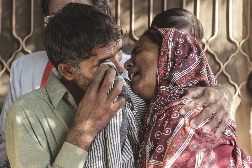Relatives of a Christian couple killed after being accused of blasphemy cry at their home in Kasur, Pakistan, Nov. 5. Catholic leaders in Pakistan protested the Nov. 4 beating to death and burning of Shahzad Masih, 28, and his pregnant wife, Shama Bibi, 24, who were accused of desecrating the Quran. (CNS photo/Rahat Dar, EPA) 