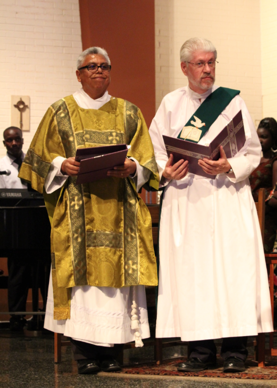 Deacons Angel Torres and Bill Jenkins read their oath of fidelity during their installation at St. Gregory Parish Nov. 16. (Ambria Hammel/CATHOLIC SUN)
