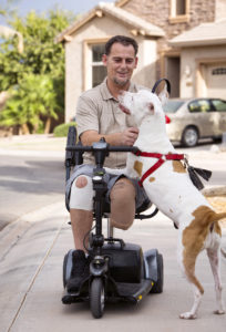 Veteran David Campbell spends time with his dog, Sugar, outside his home in Chandler, Ariz., Oct. 19. Campbell served in operations Desert Storm and Desert Shield in the early 1990s and was severely injured in a grenade explosion that nearly took his life. His message to others who have been through traumatic events is: "Help is out there and healing is possible." (CNS photo/Nancy Wiechec)  
