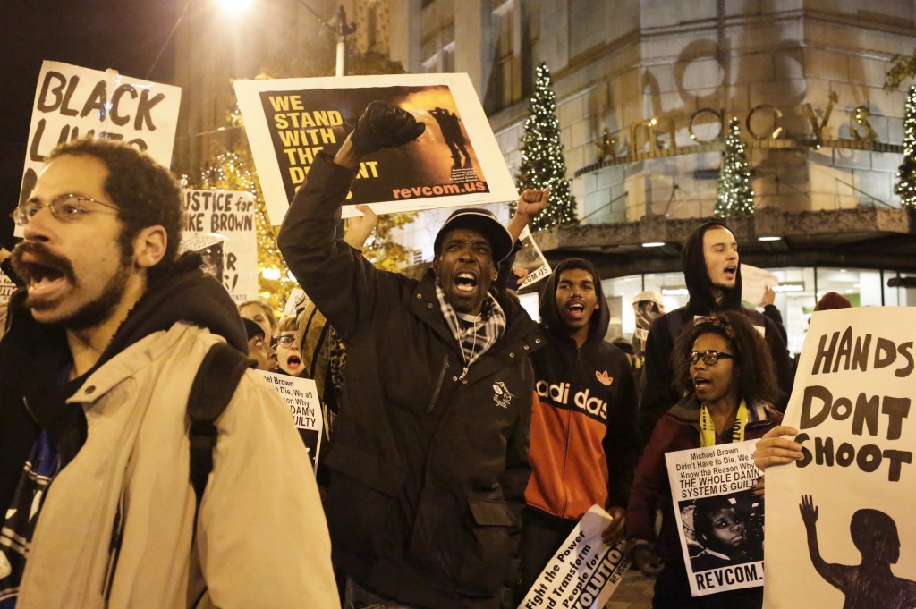 Demonstrators march through the Seattle streets Nov. 24 following a decision by a Missouri grand jury not to indict a white Ferguson police officer in the Aug. 9 fatal shooting of unarmed black teenager Michael Brown in the St. Louis suburb. (CNS photo/Jason Redmond, Reuters)