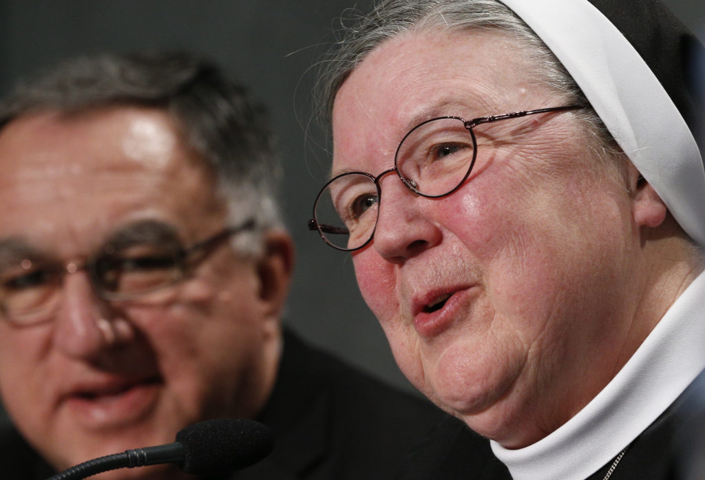 Mother Mary Clare Millea, superior general of the Apostles of the Sacred Heart of Jesus, speaks during a Dec. 16 Vatican press conference for release of the final report of a Vatican-ordered investigation of U.S. communities of women religious. Mother Millea was the Vatican-appointed director of the visitation. At left is Basilian Father Thomas Rosica, CEO of Canada's Salt and Light Media Foundation and assistant to the visitation committee. The 5,000 word report summarizes problems and challenges the women see in their communities and thanks them for their service. The visitation was carried out between 2009 and 2012. (CNS photo/Paul Haring)