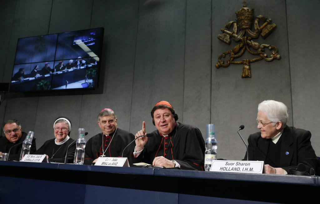 Brazilian Cardinal Joao Braz de Aviz, prefect of the Congregation for Institutes of Consecrated Life and Societies of Apostolic Life, speaks during a Dec. 16 Vatican press conference for release of the final report of a Vatican-ordered investigation of U.S. communities of women religious. The 5,000 word report summarizes problems and challenges the women see in their communities and thanks them for their service. The visitation was carried out between 2009 and 2012. From left are: Basilian Father Thomas Rosica, CEO of Canada's Salt and Light Media Foundation and assistant to the visitation committee; Mother Mary Clare Millea, superior general of the Apostles of the Sacred Heart of Jesus and the Vatican-appointed director of the visitation; Archbishop Jose Rodriguez Carballo, secretary of the Vatican's Congregation for Institutes of Consecrated Life and Societies of Apostolic Life; Cardinal Braz de Aviz; and Sister Sharon Holland, president of the Leadership Conference of Women Religious. (CNS photo/Paul Haring)