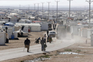 Syrian refugees walk at the Zaatari refugee camp in the Jordanian city of Mafraq, near the border with Syria, Dec. 7.  The civil war in Syria created what Antonio Guterres, the U.N. High Commissioner for Refugees, called "the defining humanitarian challenge of our times." (CNS photo/Muhammad Hamed, Reuters) 