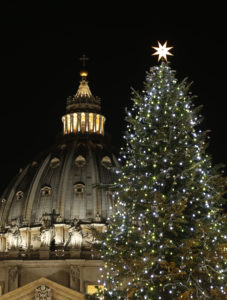 The Christmas tree and Nativity scene decorate St. Peter's Square at the Vatican after a lighting ceremony Dec. 19. New LED lighting was also unveiled on the facade and dome of the basilica during the ceremony. (CNS photo/Paul Haring)