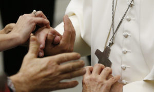 Pope Francis greets people during an audience to give Christmas greetings to Vatican employees in Paul VI hall at the Vatican Dec. 22. (CNS photo/Paul Haring) 