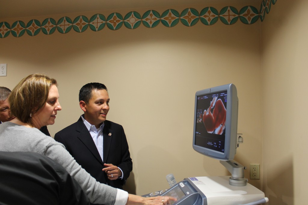 Suzanne Helzer, nurse manager at First Way, shows Dr. William Chavira the new ultrasound machine. 