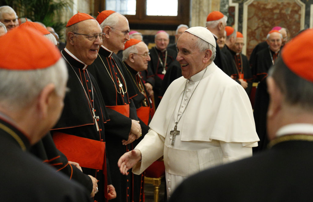 Pope Francis exchanges Christmas greetings with members of the Roman Curia during an audience in Clementine Hall at the Vatican Dec. 22. (CNS photo/Paul Haring)  