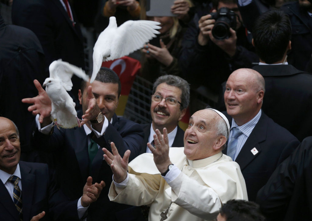 Pope Francis releases doves prior to celebrating Mass at the Cathedral of the Holy Spirit in Istanbul Nov. 29. (CNS photo/Stoyan Nenov, Reuters)  