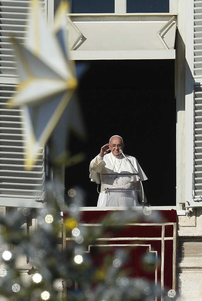 The Christmas tree decorates St. Peter's Square as Pope Francis leads the Angelus from the window of his studio overlooking the square at the Vatican Dec. 21. (CNS photo/Paul Haring)