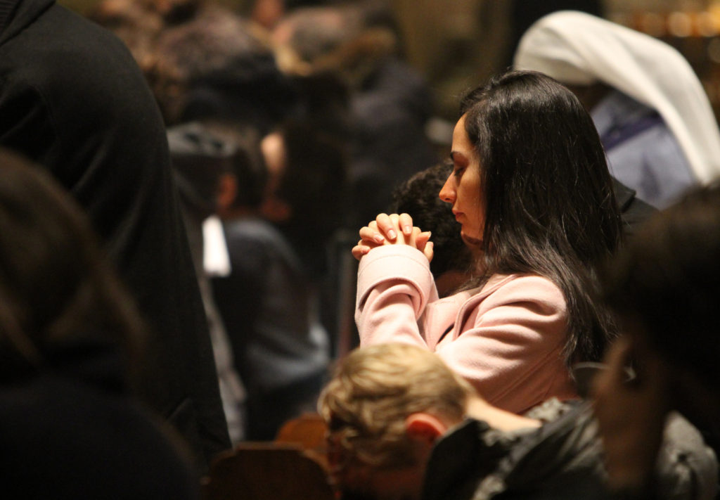 A woman prays during a French-language Mass at Notre Dame Church in New York Jan. 11. The Mass was offered for the 17 victims of the recent terror attacks in France. (CNS photo/Gregory A. Shemitz)