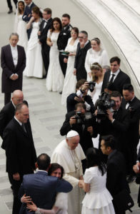 Pope Francis greets newly married couples during his general audience in Paul VI hall at the Vatican Jan. 28. (CNS photo/Paul Haring)