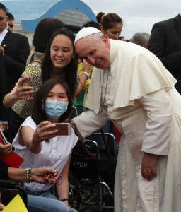 Pope Francis poses for a selfie with young women at Manila's international airport in the Philippines Jan. 17. (CNS photo/Malacanang photo bureau handout via EPA) 