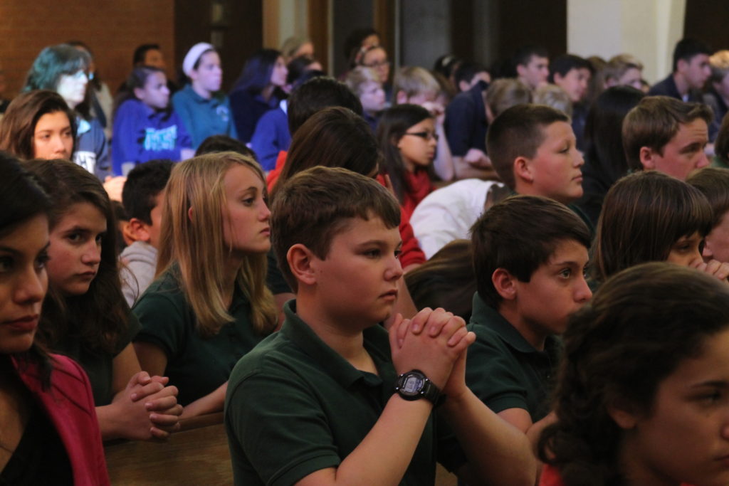 Students from Catholic schools throughout Arizona pray during the annual Catholic Schools Week Mass at Ss. Simon and Jude Cathedral in this 2014 file photo. Catholic Schools Week will be observed Jan. 25-31 this year. (Catholic Sun file photo)