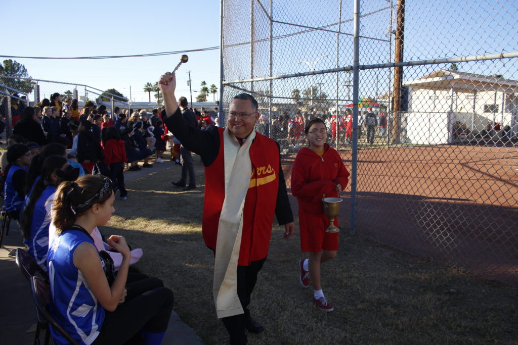 Bishop Eduardo A. Nevares blesses St. Vincent de Paul fans — and opponents — Jan. 22 during a dedication ceremony for the school's revamped ball field. (Ambria Hammel/CATHOLIC SUN)