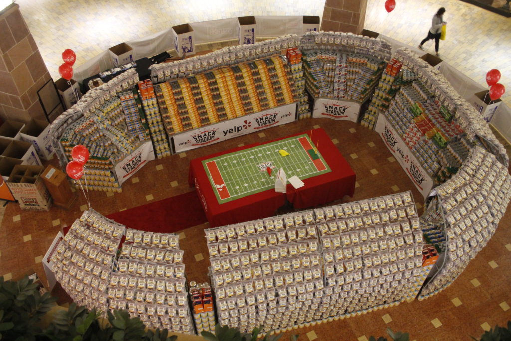 "Snack Stadium" on display at Scottsdale Fashion Square is made of more than 30,000 non-perishable products donated by the companies. The community can add to the collection and drop off monetary donations during mall hours through Jan. 31. Proceeds will be given to St. Vincent de Paul, one of the participating agencies in the "PlayBook for Common Good" event coming Jan 31 to the Diocesan Pastoral Center in Phoenix. (Ambria Hammel/CATHOLIC SUN)