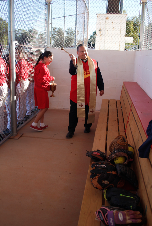 Bishop Nevares blesses St. Vincent de Paul's first shaded dugouts Jan. 22. The tigers can now truly rest between at-bats. (Ambria Hammel/CATHOLIC SUN)