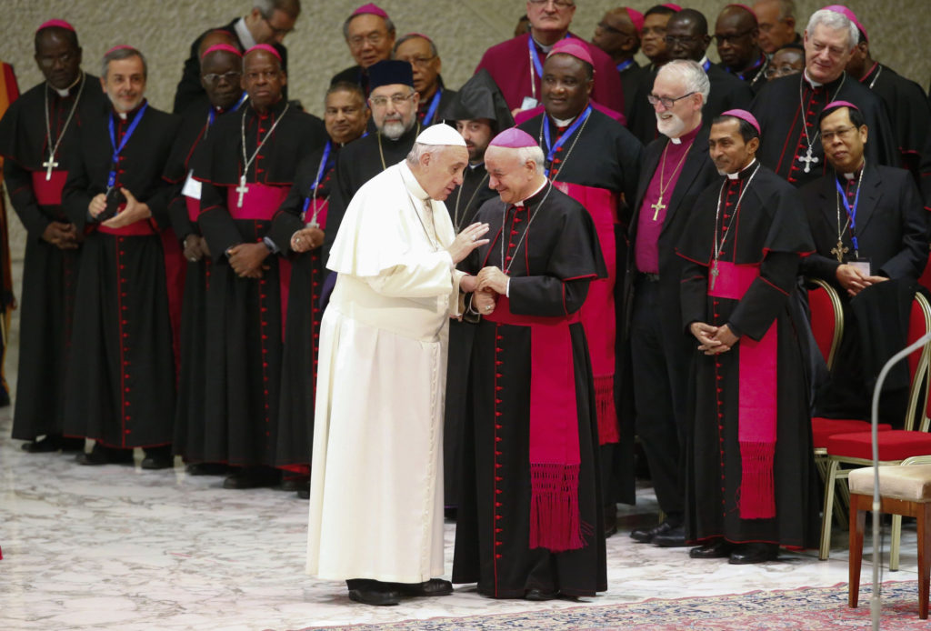 Pope Francis talks with Archbishop Vincenzo Paglia, president of the Pontifical Council for the Family, as the pontiff arrives to lead his weekly audience in Paul VI hall at the Vatican Feb. 4. (CNS photo/Tony Gentile, Reuters)