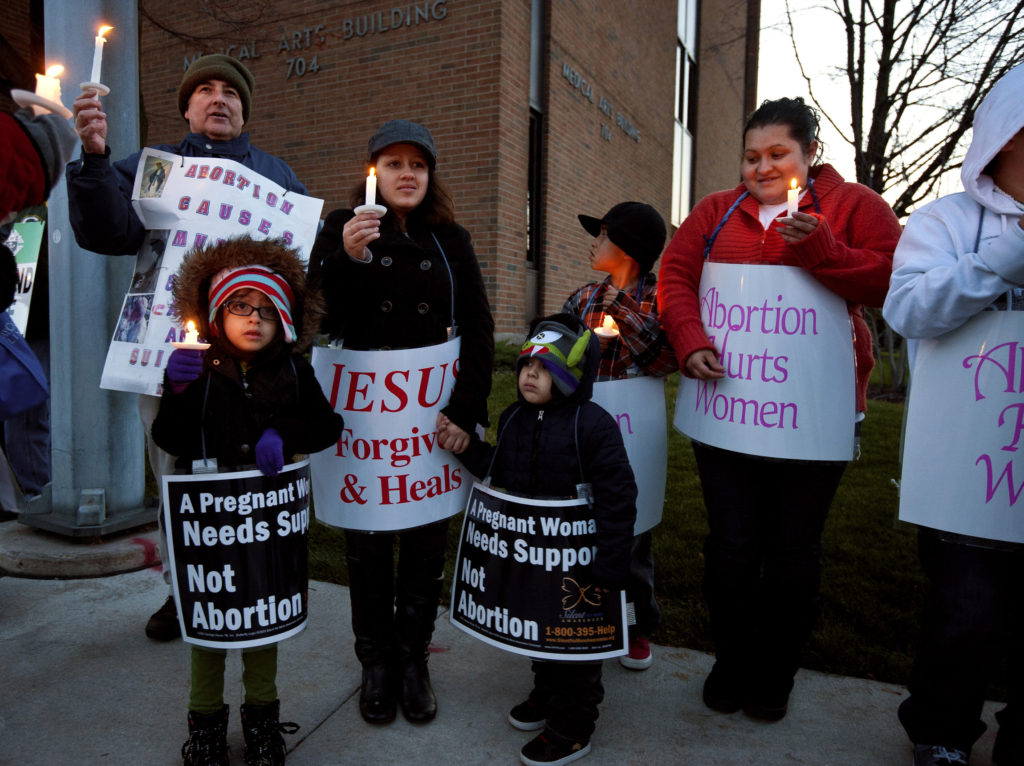 Marisol Garcia, second from left, and her children Lexani and Alexzander Diaz, attend a prayer vigil Nov. 4 outside a clinic that performs abortions in Green Bay, Wis. The parishioners of St. Willebrord Church joined other pro-life advocates at the end of the 40 Days for Life campaign, an annual national observance to pray and campaign for an end to abortion. (CNS photo/Sam Lucero, The Compass) 