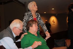 Ed and Mary Ann Wilmowski, longtime members of City of the Lord, pray over Ellen Sweeney at a healing prayer service Jan. 21 at St. Timothy Parish. The Wilmowskis and other members of COTL help out at the monthly gatherings. (Joyce Coronel/CATHOLIC SUN)