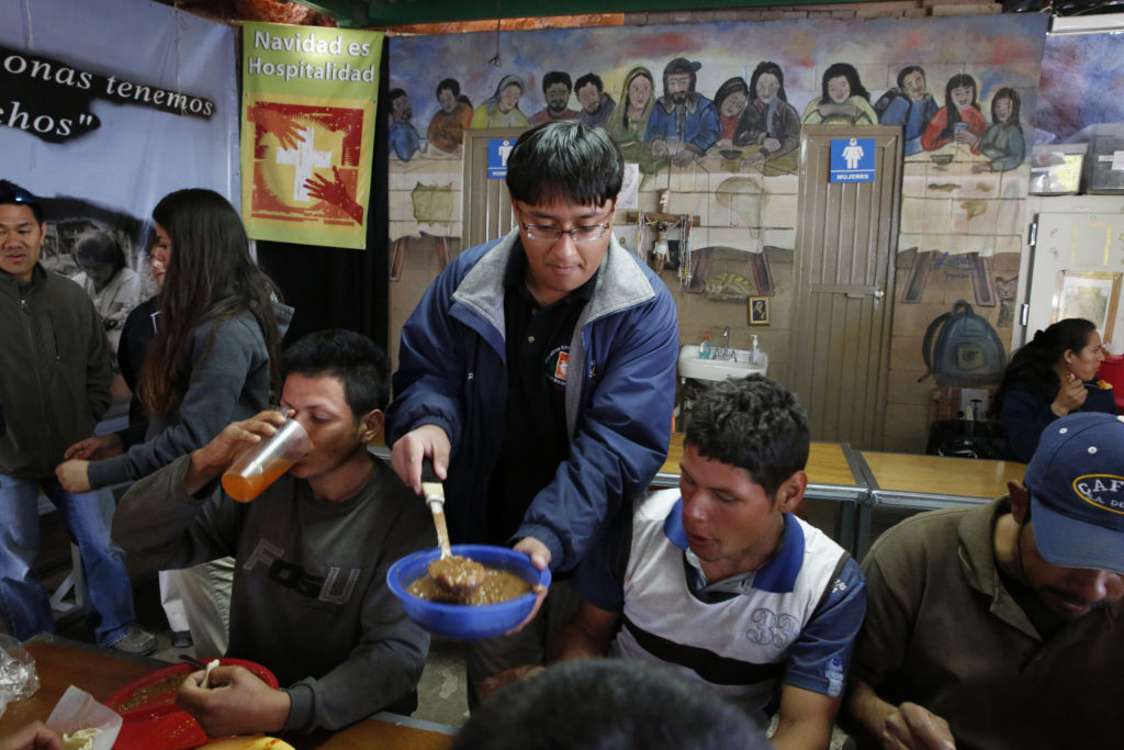 Kino Teen Gerardo Perez serves beans to deported migrants in 2014 at the "comedor," the kitchen and dining hall of the Aid Center for Deported Migrants in Nogales, Mexico. Pope Francis wrote a personal letter to the Kino Border Initiative's executive director praising and encouraging the teens in their work for migrants. (CNS photo/Nancy Wiechec)  