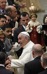 A statue of the child Jesus is seen as Pope Francis greets people during his general audience in Paul VI hall at the Vatican Jan. 28. The pope continued talking about the role of fatherhood Feb. 4. (CNS photo/Paul Haring)