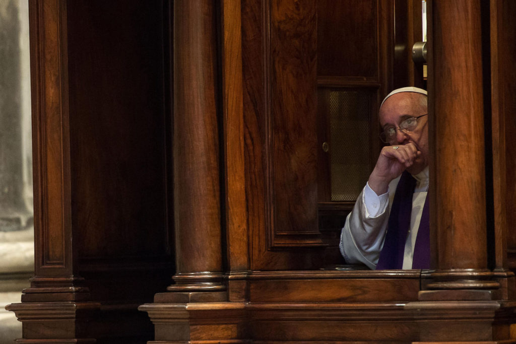 Pope Francis hears confession during a penitential liturgy in St. Peter's Basilica at the Vatican during the 2014 Lenten season. Pope Francis surprised his liturgical adviser by going to confession during the service. (CNS photo/L'Osservatore Romano via Reuters) 