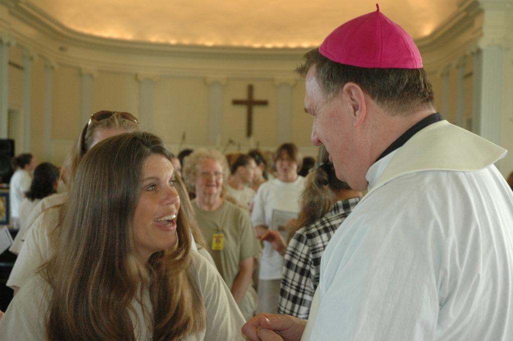 Constance Tomich shares a smile and a conversation with Archbishop Joseph W. Tobin of Indianapolis following a 2014 Mass he celebrated in the chapel at the Indiana Women's Prison in Indianapolis June 29. Some Catholics who volunteer at prisons say their lives have been changed through their prison ministry. (CNS photo/John Shaugnessy, The Criterion)