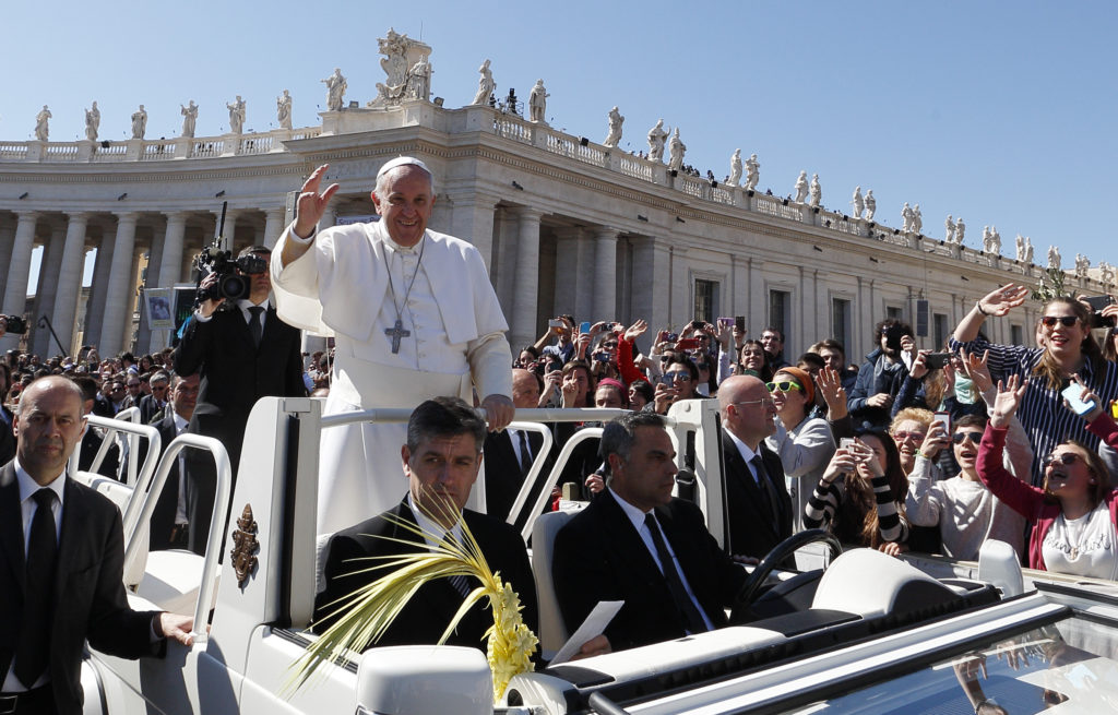 Pope Francis greets the crowd after celebrating Palm Sunday Mass in St. Peter's Square at the Vatican March 29. (CNS photo/Paul Haring)