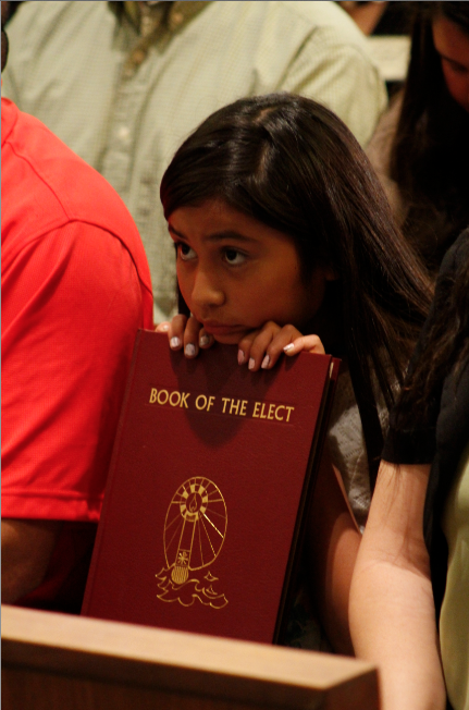 A young girl holds her parish's Book of Elect during the Rite of Election at Ss. Simon and Jude Cathedral in Phoenix Feb. 22. (Ambria Hammel/CATHOLIC SUN)