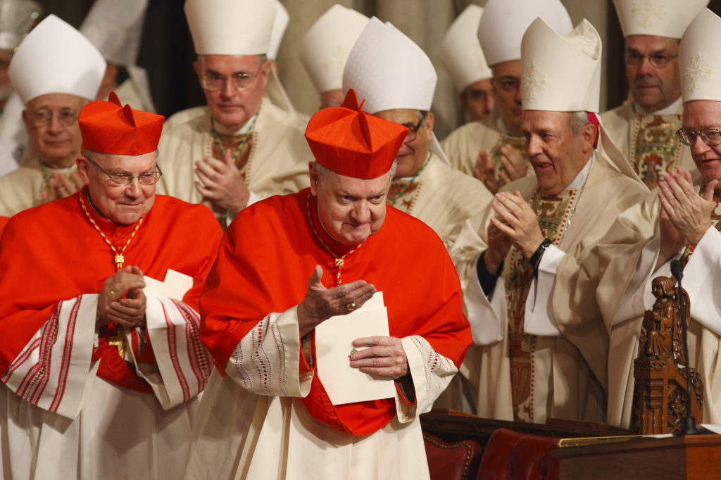 Cardinal Edward M. Egan, center, retired archbishop of New York, acknowledges applause as he is thanked for his service during Archbishop Timothy M. Dolan's 2009 installation Mass at St. Patrick's Cathedral in New York. (CNS photo/Paul Haring)