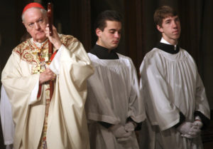 Cardinal Edward M. Egan holds his crosier as he celebrates his final Easter Mass as head of the Archdiocese of New York at St. Patrick's Cathedral in this 209 file photo. Pope Benedict XVI named Milwaukee Archbishop Timothy M. Dolan to succeed Cardinal Egan as head of the nation's second largest archdiocese. (CNS photo/Patrick Andrade, Reuters) 