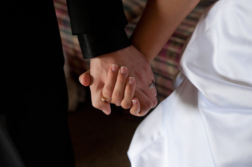 A groom and bride hold hands on their wedding day. Catholic marriages in the United States are at their lowest point since 1965. (CNS file photo/Jon L. Hendricks)