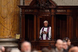 A priest participates from his confessional as Pope Francis leads a Lenten penance service in St. Peter's Basilica at the Vatican March 13. During the service the pope announced an extraordinary jubilee, a Holy Year of Mercy, to be celebrated from Dec. 8, 2015, until Nov. 20, 2016. (CNS photo/Paul Haring) 