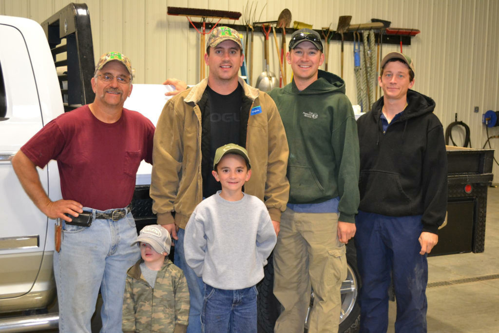 Tony Horinek poses in 2014 at his farm in Colby, Kan., with his sons, Clint and Aaron, and full-time employee Martin Lager, right. In front are Aaron's sons Simeon and Edward. For the Horinek family in far western Kansas, the potential to pass down the farm to the next generation is a blessing, said Tony Horinek. (CNS photo/Photos courtesy of the Horinek family) 