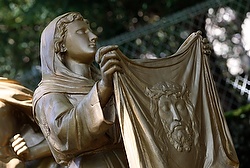 In this May 17, 2014, photo, Veronica wipes the face of Jesus in this representation of the sixth Station of Cross at the Shrine of Our Lady of Lourdes in southwestern France. (CNS photo/Paul Haring) 