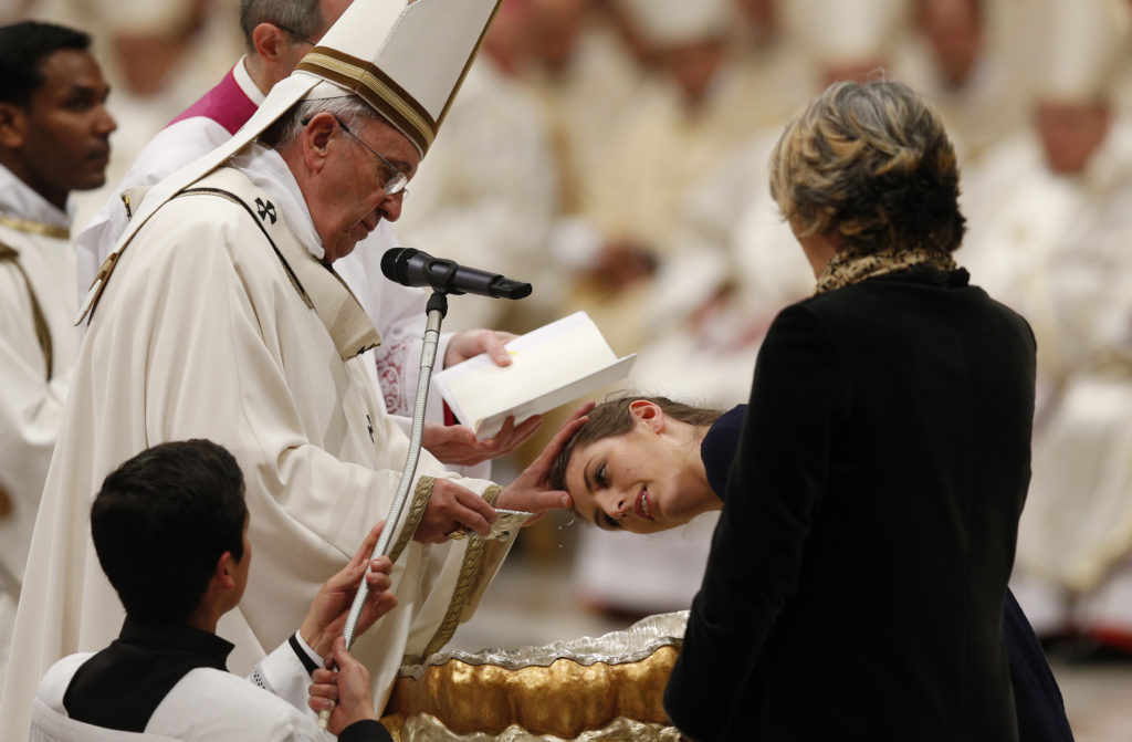 Pope Francis baptizes Giulia Riccardi from Italy during the Easter Vigil in St. Peter's Basilica at the Vatican April 4. (CNS photo/Paul Haring)