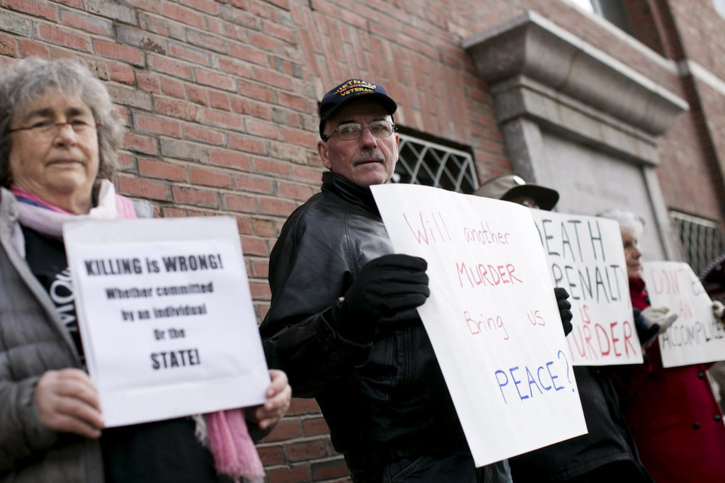 Protesters against the death penalty hold signs before closing arguments took place April 6 in the trial of accused Boston Marathon bomber Dzhokhar Tsarnaev at the federal courthouse in Boston. The bishops of Massachusetts urged against a death sentence for the bombing defendant, reiterating Catholic teaching that says cases where capital punishment is acceptable are practically nonexistent. (CNS photo/Dominick Reuter, Reuters)