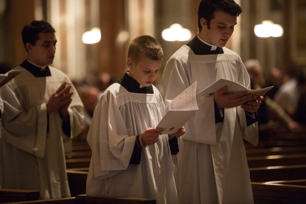 Brett Haubrich, a sixth-grader at St. Mark School in Affton, Mo., who was diagnosed with a brain tumor last summer, center, walks with seminarians during Mass on Holy Thursday, April 2, at the Cathedral Basilica of St. Louis. At the invitation of St. Louis Archbishop Robert J. Carlson, Brett took his place beside the altar at the cathedral as "Priest for a Day." (CNS photo/Lisa Johnston, St. Louis Review)