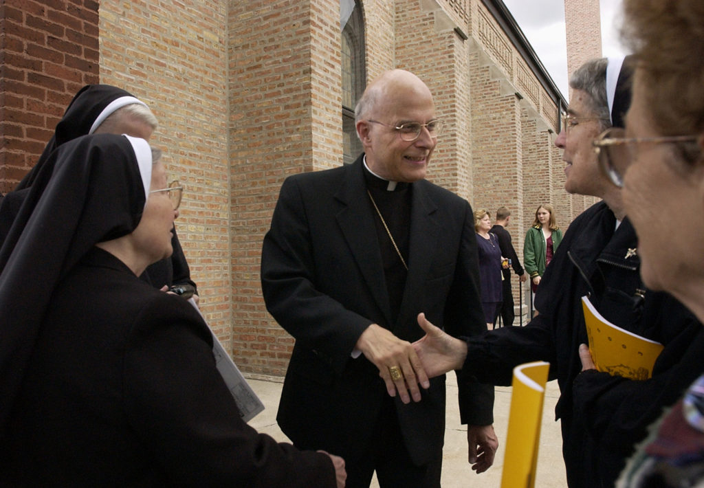 Cardinal Francis George greets people in 2003 following Mass in celebration of the 100th Anniversary of St. George's Church in Chicago. Cardinal George, 78, died April 17 after a long battle with cancer. 