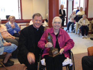 Mercy Sister Mary Ann Walsh poses for a photo March 12 with Salt Lake City Bishop John C. Wester, chairman of the U.S. bishops' Committee on Communications, in the community room at the Sisters of Mercy motherhouse in Albany, N.Y. Sister Walsh received Catholic Press Association's St. Francis de Sales Award. (CNS photo/Helen Osman)