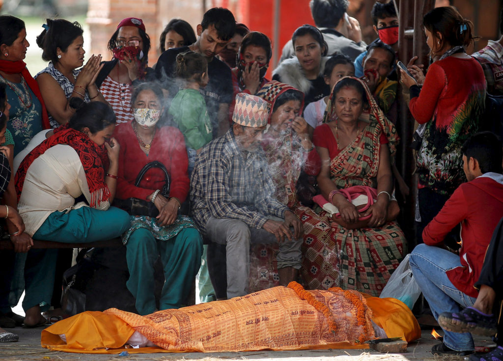 Relatives of an earthquake victim mourn before cremation in Kathmandu, Nepal, April 27.  More than 3,600 people were known to have been killed and more than 6,500 others injured after a magnitude-7.8 earthquake hit a mountainous region near Kathmandu on Mount Everest April 25. (CNS photo/Danish Siddiqui, Reuters) 