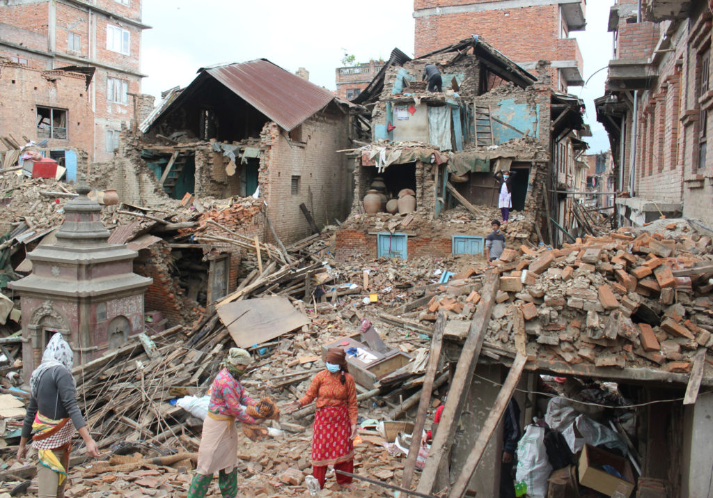 Earthquake survivors of Harsiddhi village on the outskirts of Kathmandu, Nepal, retrieve belongings from their destroyed homes April 29, five days after a major earthquake struck the region. (CNS photo/Anto Akkara)  April 29, 2015.