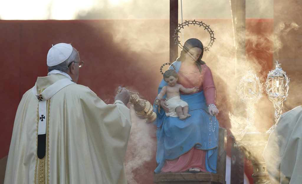 Pope Francis burns incense in front of a statue of Mary and relics of  Sts. John XXIII and John Paul II as he celebrates Mass at the Verano cemetery in Rome Nov. 1, the feast of All Saints. (CNS photo/Paul Haring) 