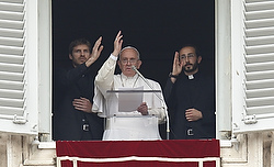 Pope Francis and Fathers Davide Maria Tisato and Elia Del Prete, both newly ordained priests, help lead the "Regina Coeli" from the window of the pope's studio at the Vatican April 26. The priests and 17 others were ordained by the pope during a liturgy in St. Peter's Basilica that morning. A priestly ordination in Nepal the day prior saved many villagers from earthquake-related injury and death, according to one man. (CNS photo/Paul Haring) 