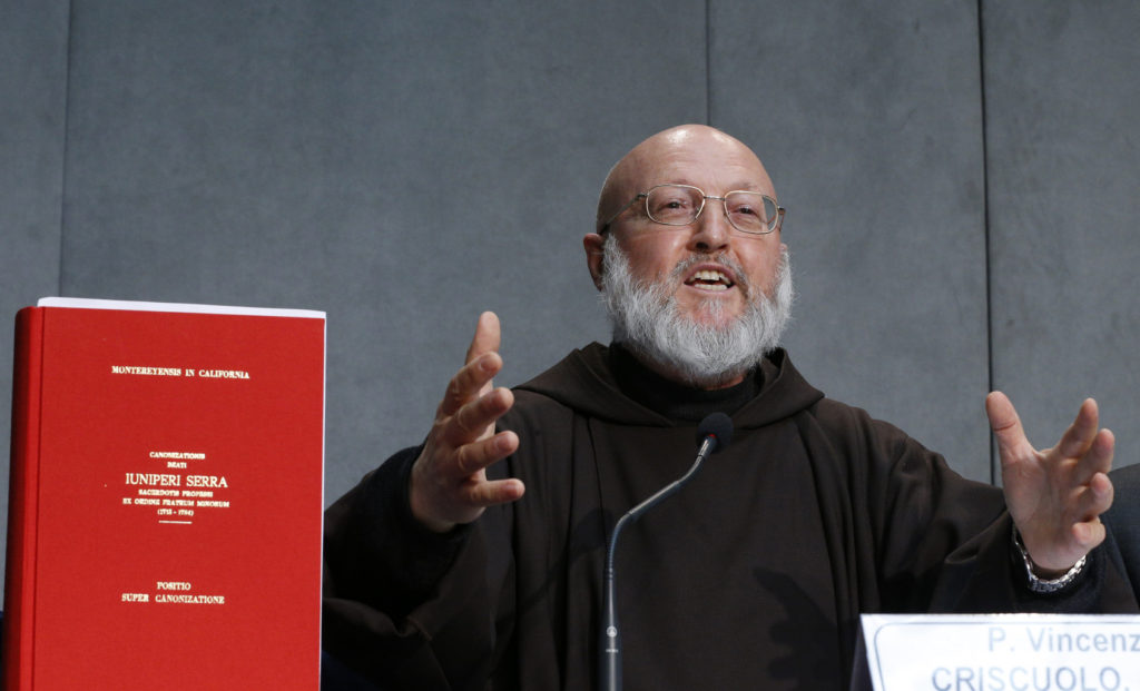 Capuchin Father Vincenzo Criscuolo speaks next to the "positio," or position paper on Blessed Junipero Serra during a press conference at the Vatican April 20. Pope Francis will canonize Blessed Serra Sept. 23 in Washington during his visit to the United States. (CNS photo/Paul Haring)